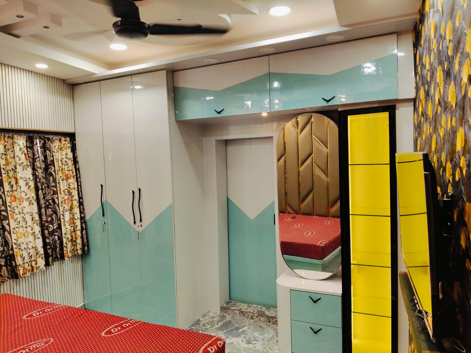 Wardrobe and dressing unit beside bed