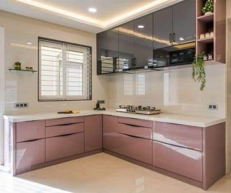 L-shaped modular kitchen with pink lower cabinets