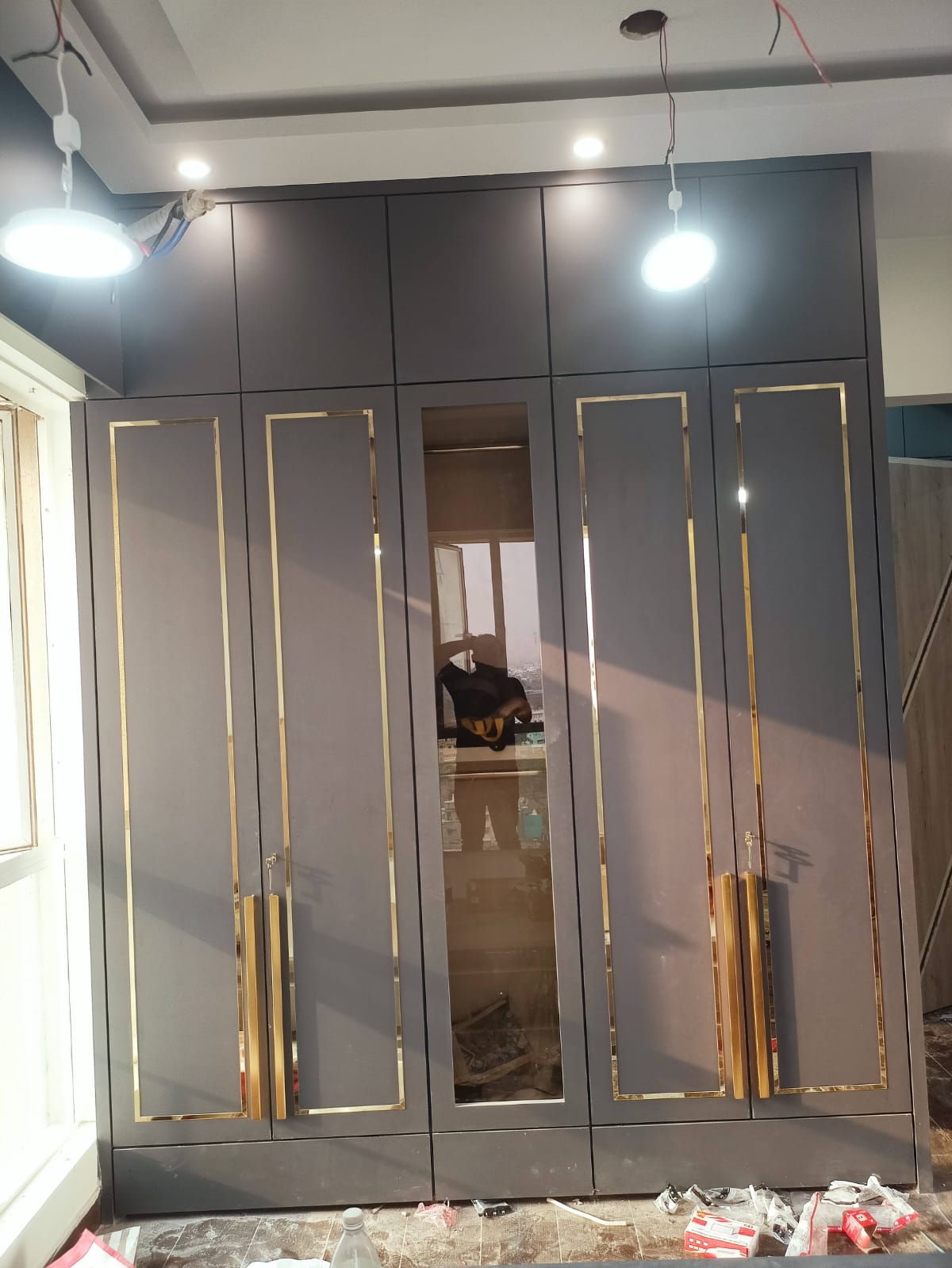 Grey bedroom wardrobe with gold border finish