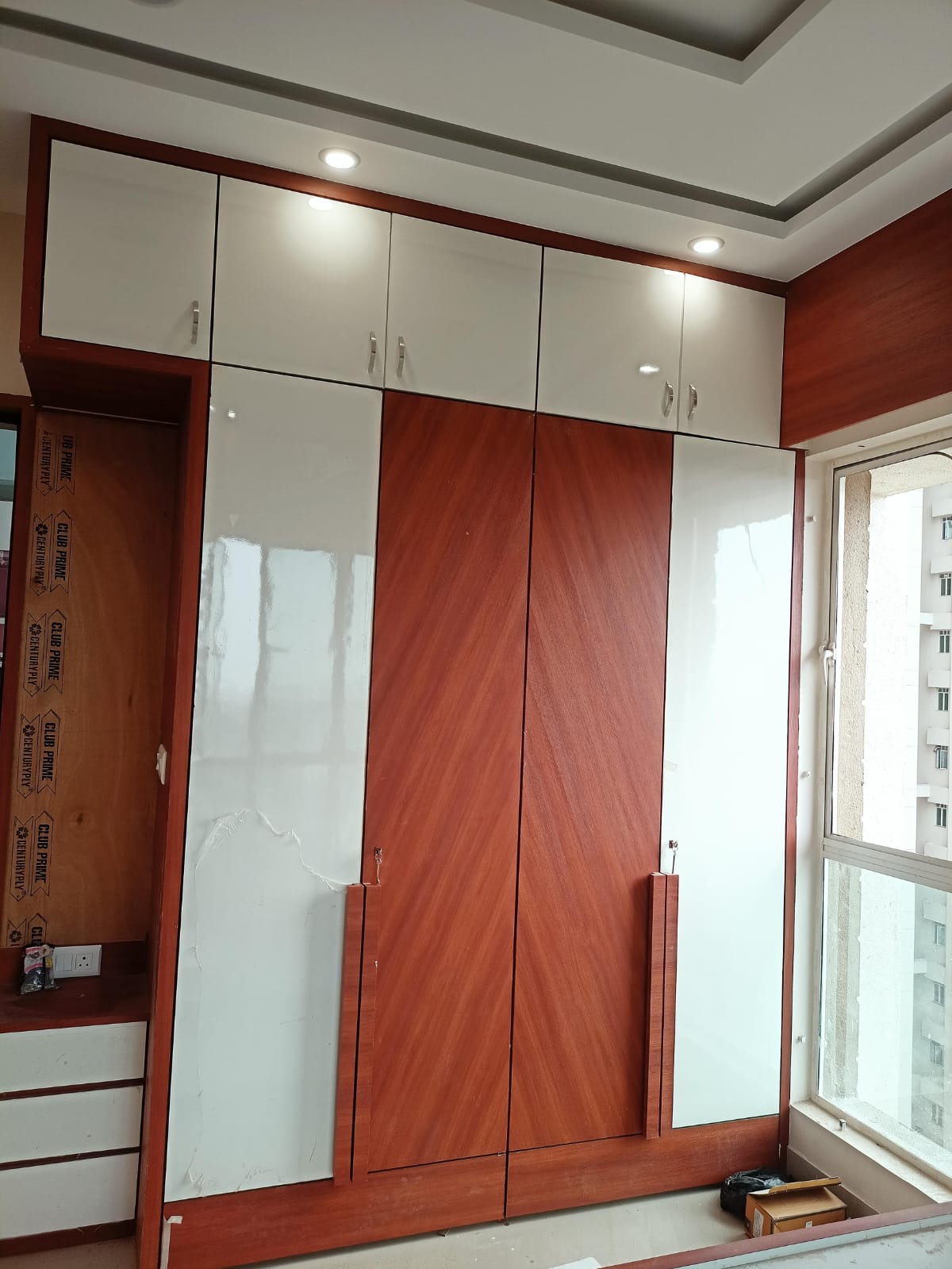 Wood and white bedroom wardrobe with overhead storage
