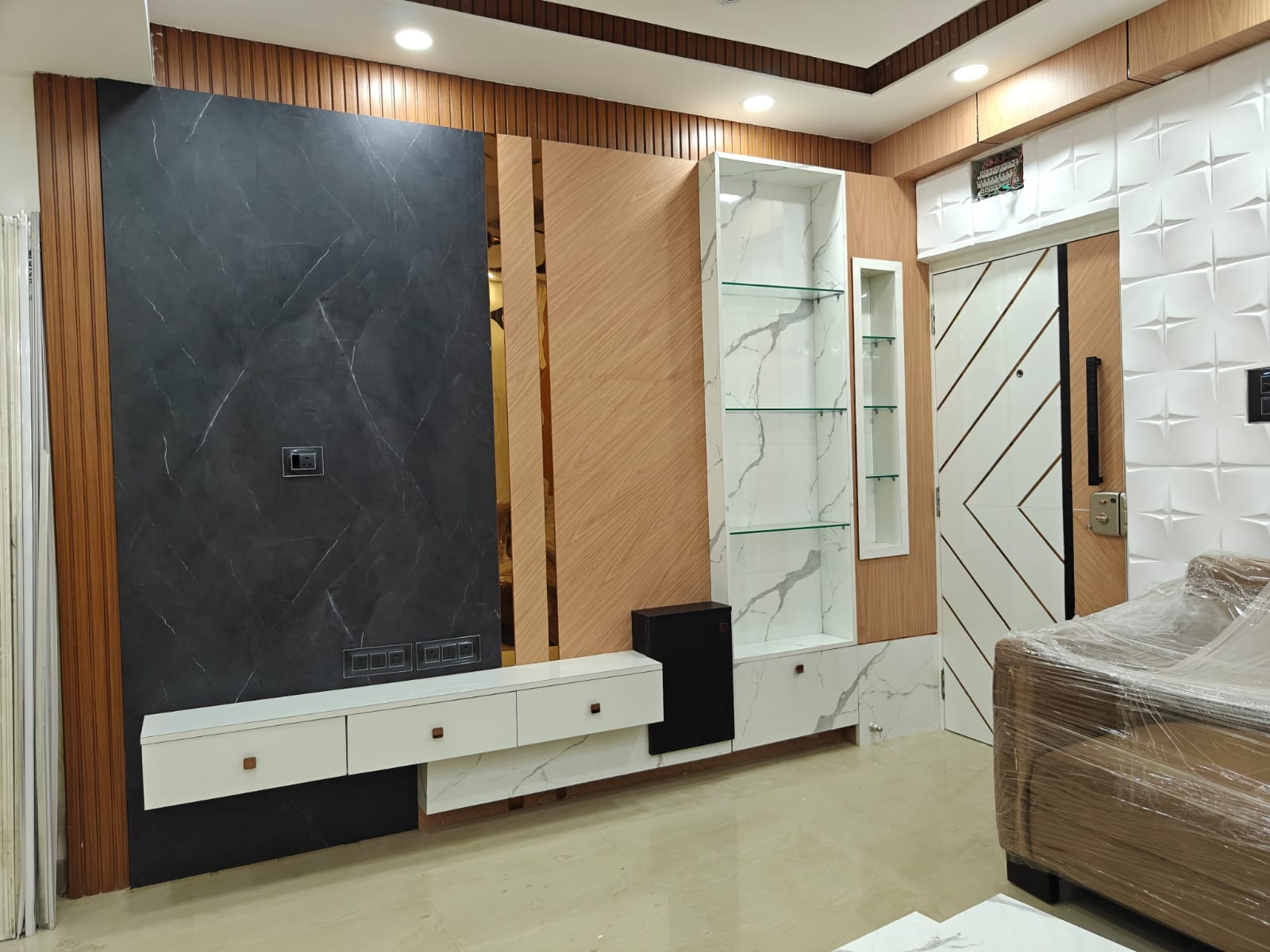 TV unit with display shelves and wall panel design
